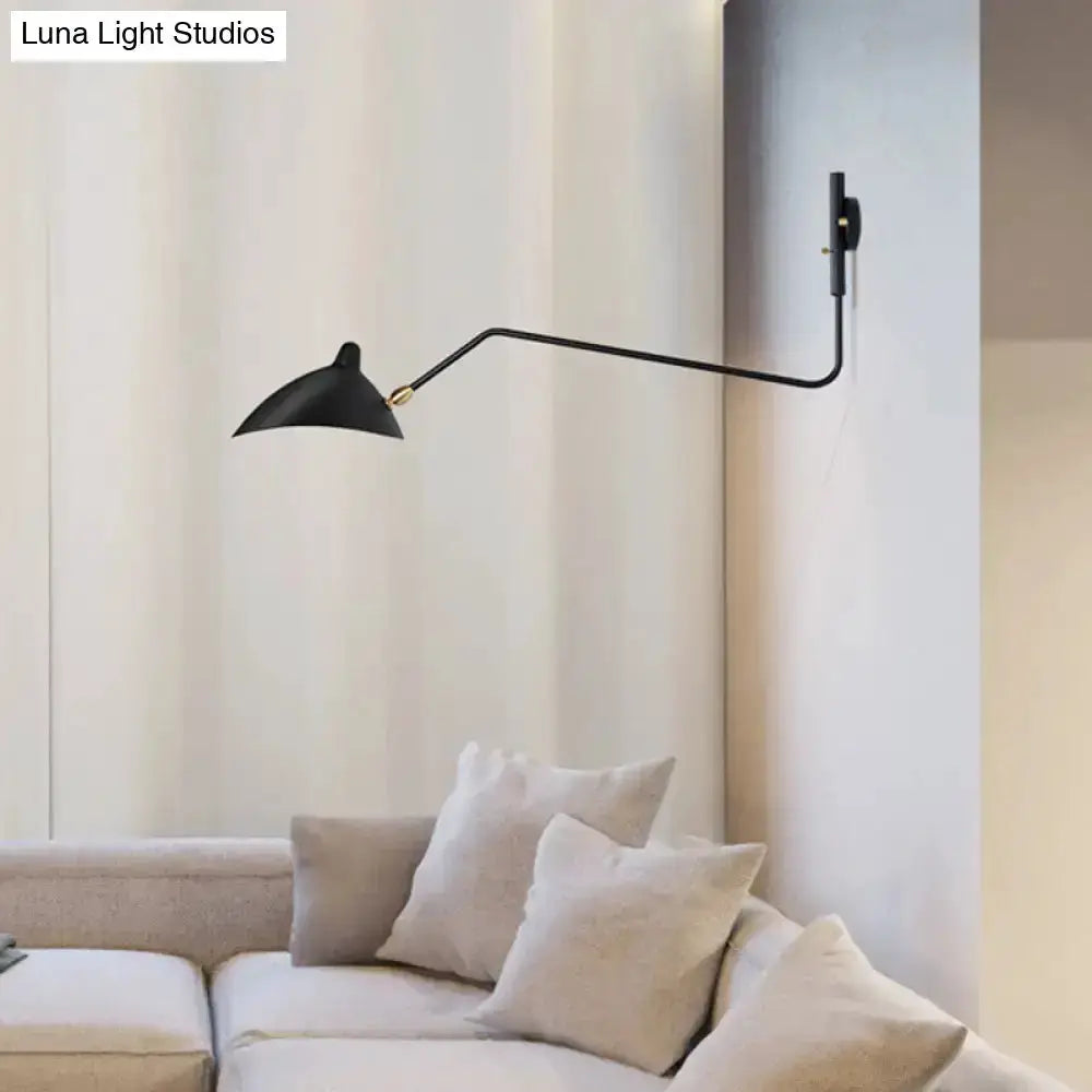 Articulated wall sconce by Decorbites, black with swing-arm over beige living room sofa on Tampa Home & Garden Store