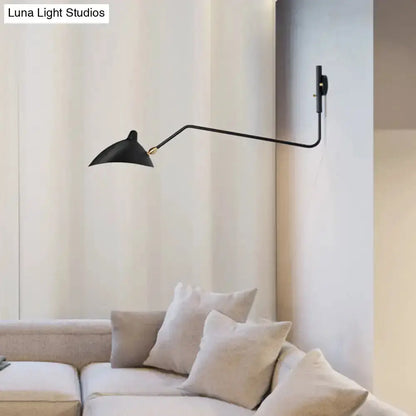Articulated wall sconce by Decorbites, black with swing-arm over beige living room sofa on Tampa Home & Garden Store