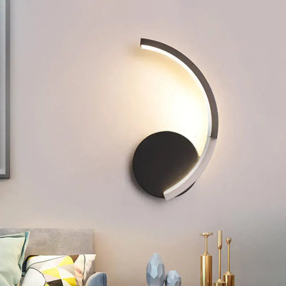 Decorbites curved LED wall sconce with black round base and illuminated arc light on Tampa Home & Garden Store