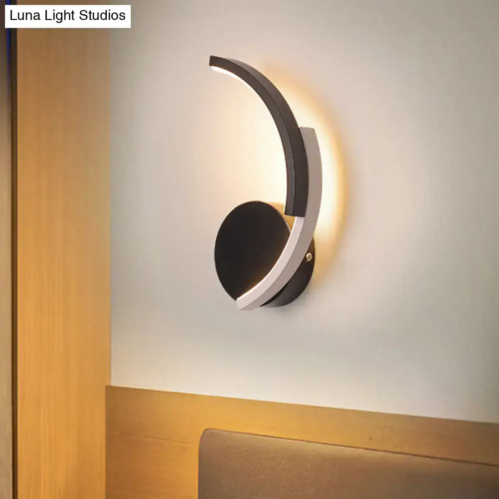 Decorbites Curved LED Wall Sconce in black and white metal with warm glow on Tampa Home & Garden Store