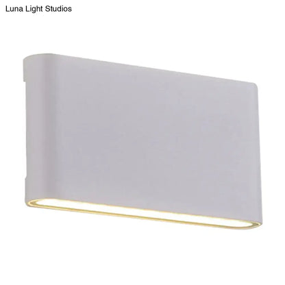 White oblong wall lamp by Decorbites with warm underside glow on Tampa Home & Garden Store