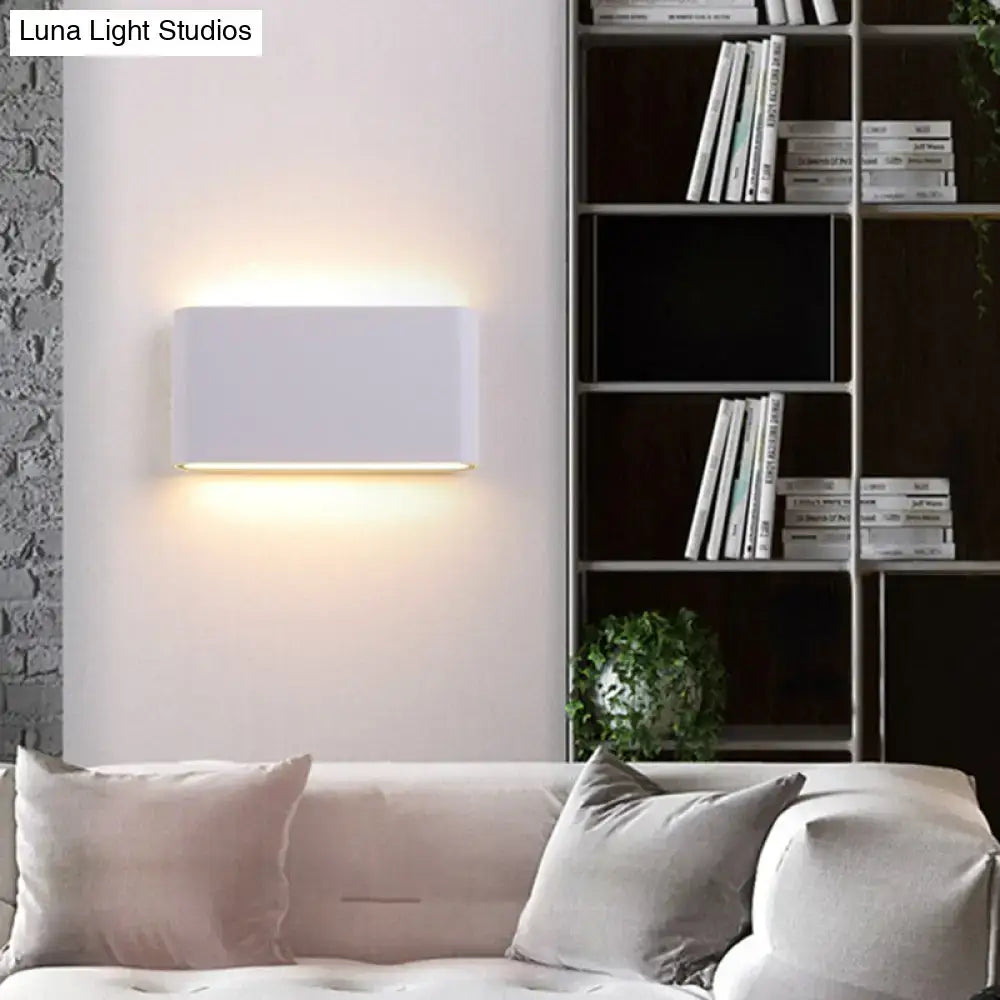 Black oblong wall lamp wall sconce by Decorbites with warm uplight and downlight on Tampa Home & Garden Store