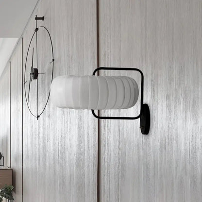 Black pumpkin wall sconce by Decorbites with ribbed white glass shade and black frame on Tampa Home & Garden Store