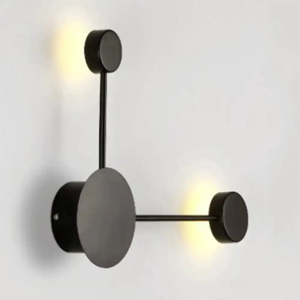 Geometric wall sconce by Decorbites in black and white with circular backplate on Tampa Home & Garden Store