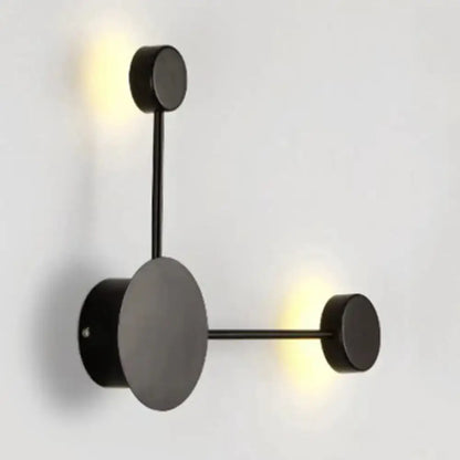 Geometric wall sconce by Decorbites in black and white with circular backplate on Tampa Home & Garden Store