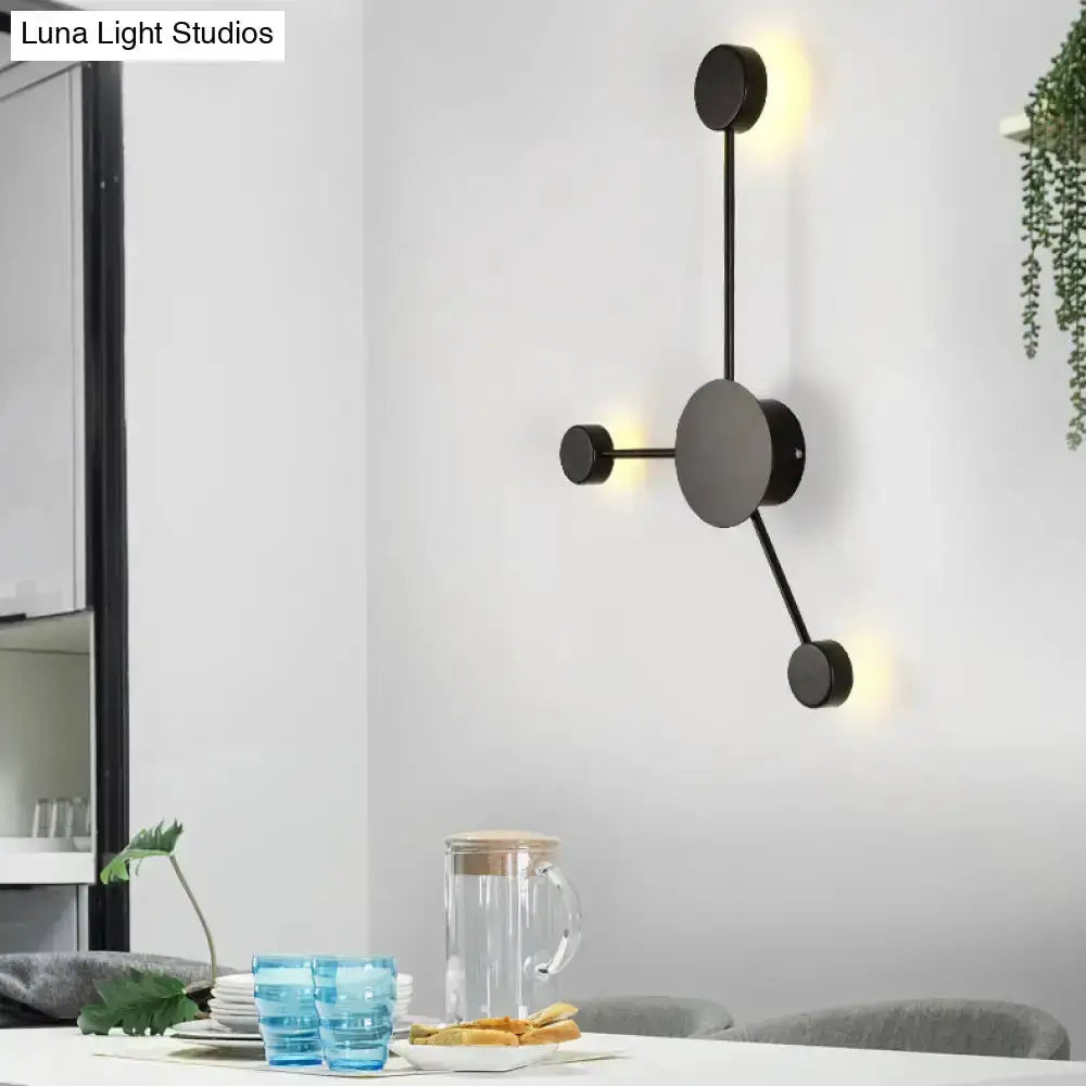 Decorbites modern black metal geometric wall sconce with circular discs and warm LED glow on Tampa Home & Garden Store