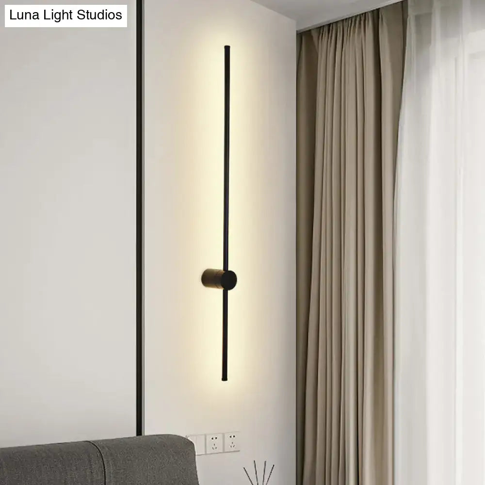 Modern black LED metal wall sconce with vertical bar and central mount, warm backlight on Tampa Home & Garden Store