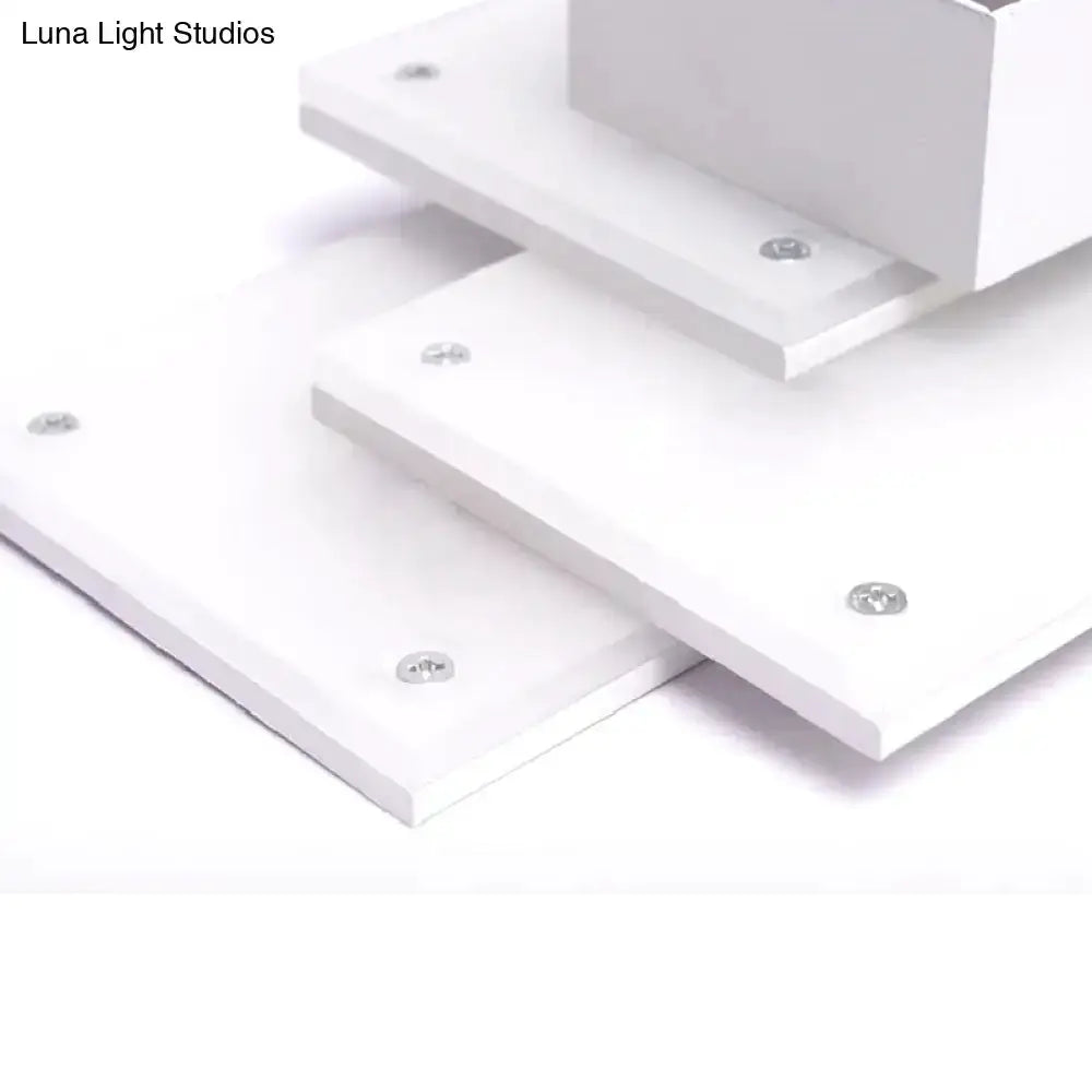 Modern white LED wall lamp fixture with stacked panels and visible screws on Tampa Home & Garden Store