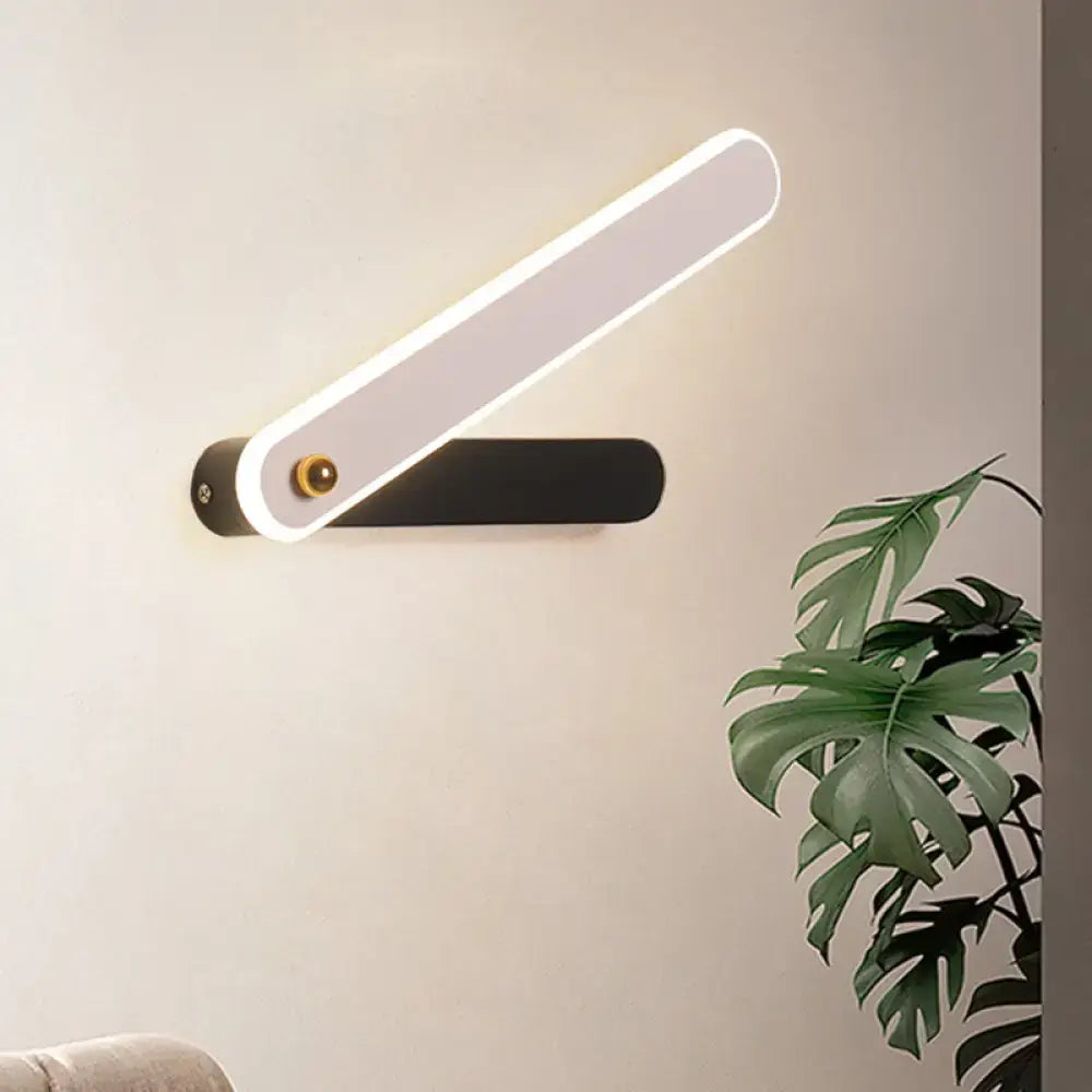 Black metal LED sconce by Decorbites, modern wall light with angled illuminated bar on Tampa Home & Garden Store