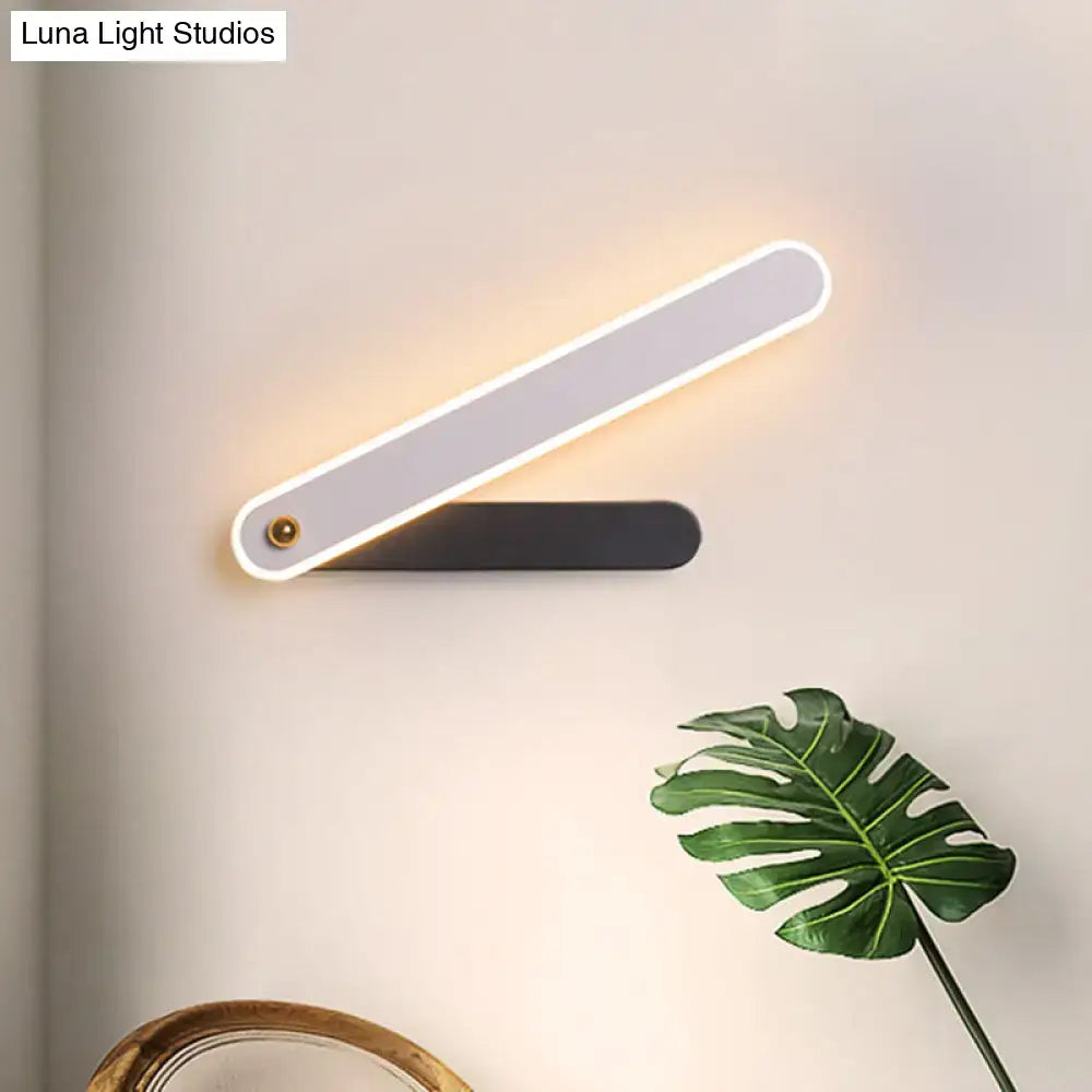 Black metal LED sconce by Decorbites with white illuminated strip and dual bars on wall on Tampa Home & Garden Store