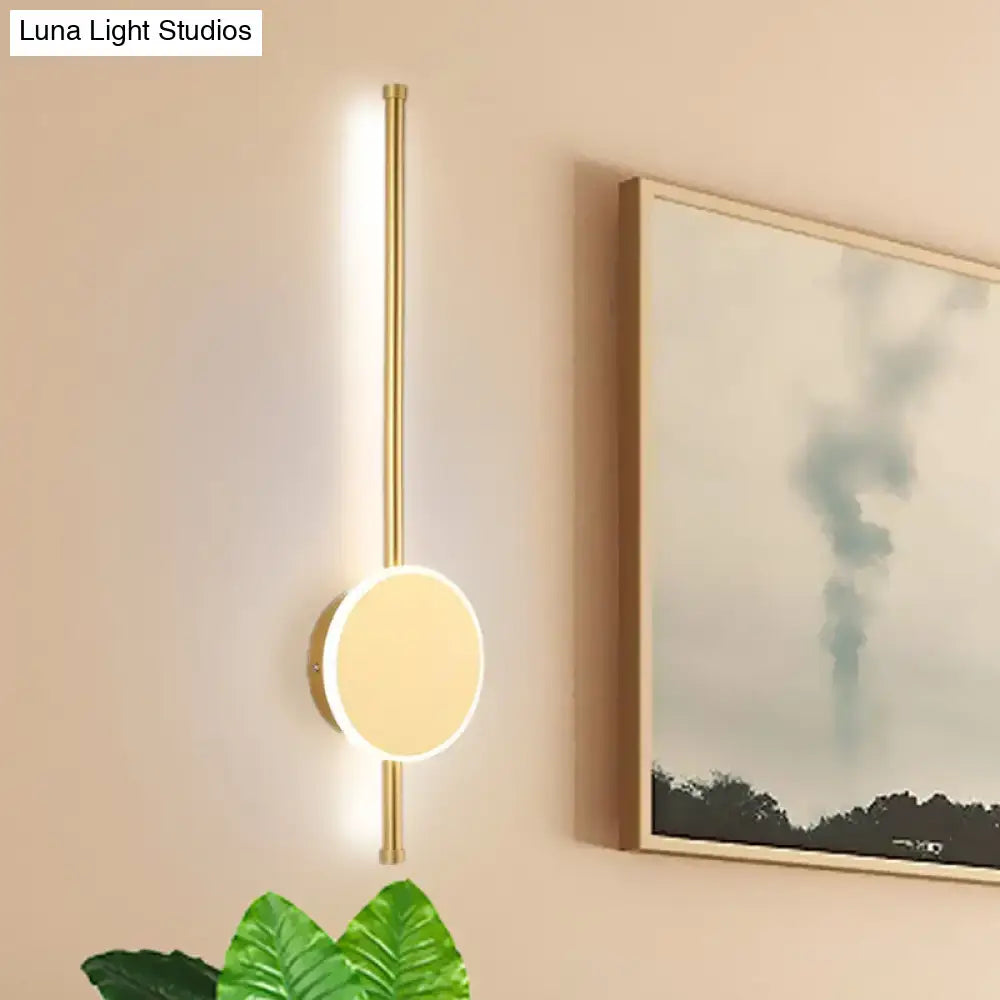 Decorbites white LED wall sconce with brass vertical mount and circular disk light on Tampa Home & Garden Store