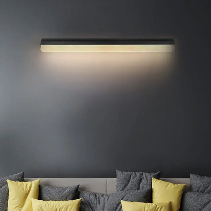 Modern black and white linear LED wall light sconce by Decorbites on dark wall on Tampa Home & Garden Store