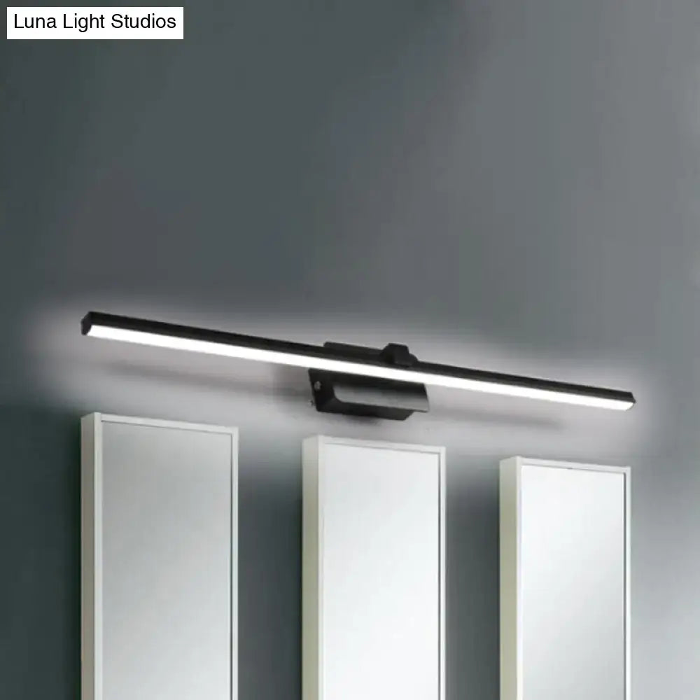 Black iron vanity light bar with LED, mounted above three white bathroom cabinets on Tampa Home & Garden Store