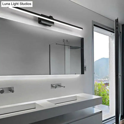Black Iron Vanity Light by Decorbites mounted above white bathroom vanity with large mirror on Tampa Home & Garden Store