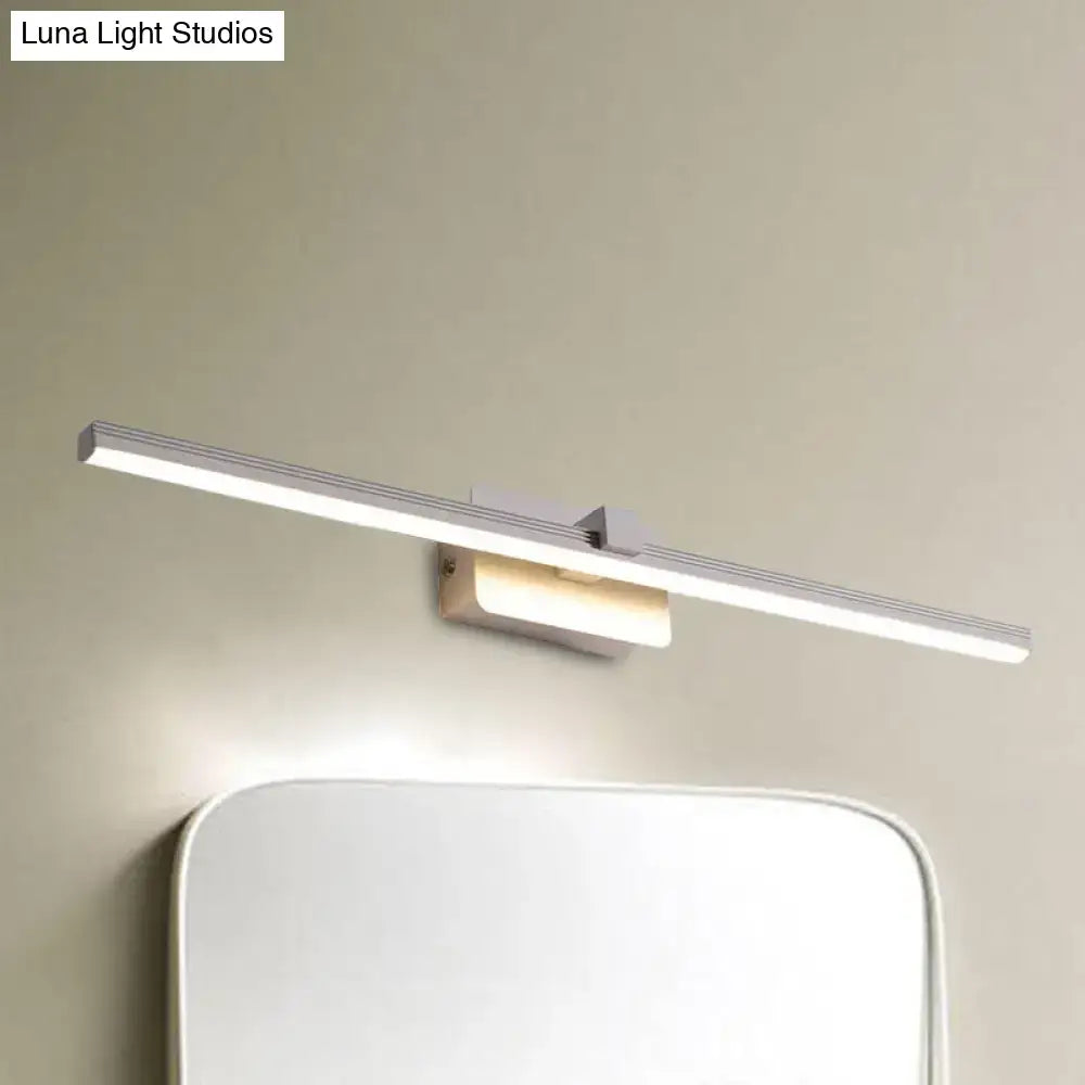 Black iron vanity light with a long linear LED bar mounted above a mirror on a beige wall on Tampa Home & Garden Store