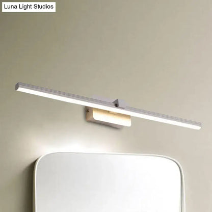Black iron vanity light with a long linear LED bar mounted above a mirror on a beige wall on Tampa Home & Garden Store