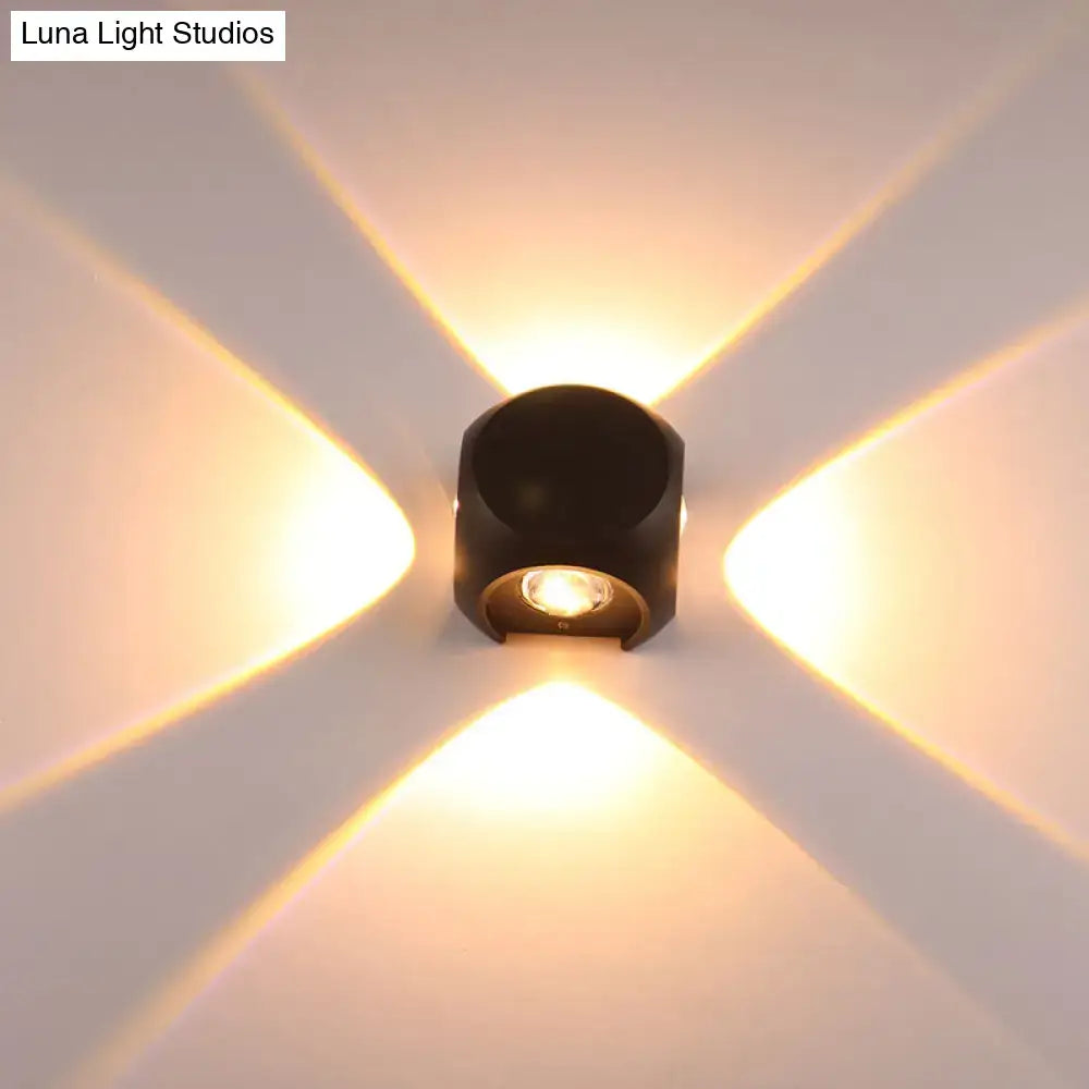 Mini Cube Wall Sconce by Decorbites, black metal with warm LED, creates cross-pattern glow on wall on Tampa Home & Garden Store