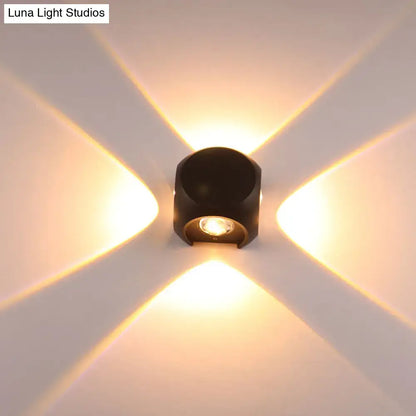 Mini Cube Wall Sconce by Decorbites, black metal with warm LED, creates cross-pattern glow on wall on Tampa Home & Garden Store