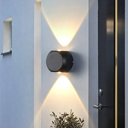 Decorbites Mini Cube Wall Sconce, black cylindrical wall light with up-down glow on white wall on Tampa Home & Garden Store