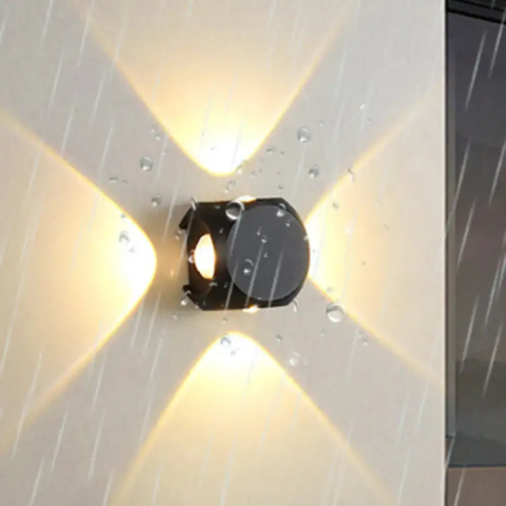 Mini Cube Wall Sconce by Decorbites, black metal cube with warm cross-light on rainy wall on Tampa Home & Garden Store