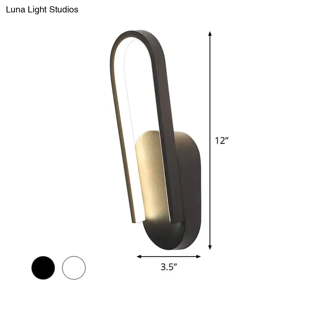 Black metal acrylic parlor wall sconce with curved loop and gold interior by Decorbites on Tampa Home & Garden Store
