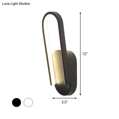 Black metal acrylic parlor wall sconce with curved loop and gold interior by Decorbites on Tampa Home & Garden Store