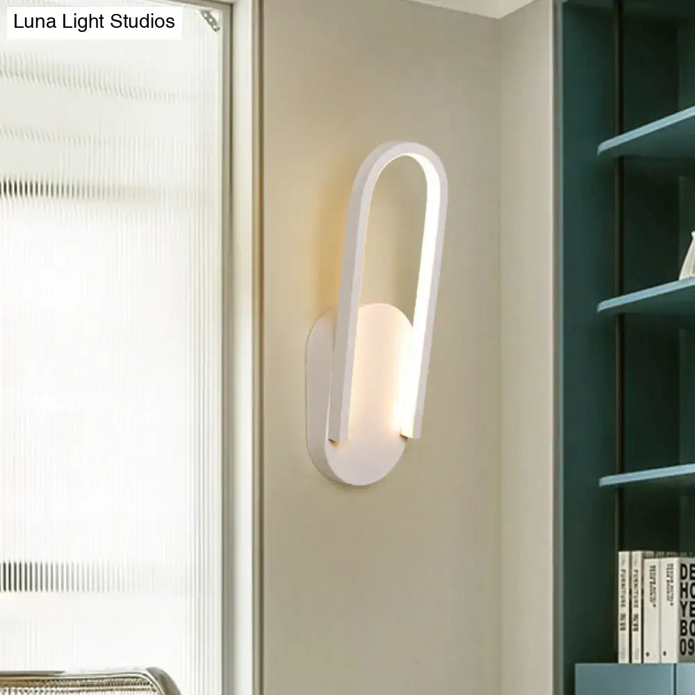 Black metal acrylic parlor wall sconce with curved loop frame and frosted diffuser on Tampa Home & Garden Store