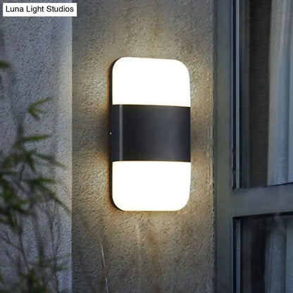 Decorbites black rectangle cast iron outdoor wall sconce with white glass top and bottom panels on Tampa Home & Garden Store