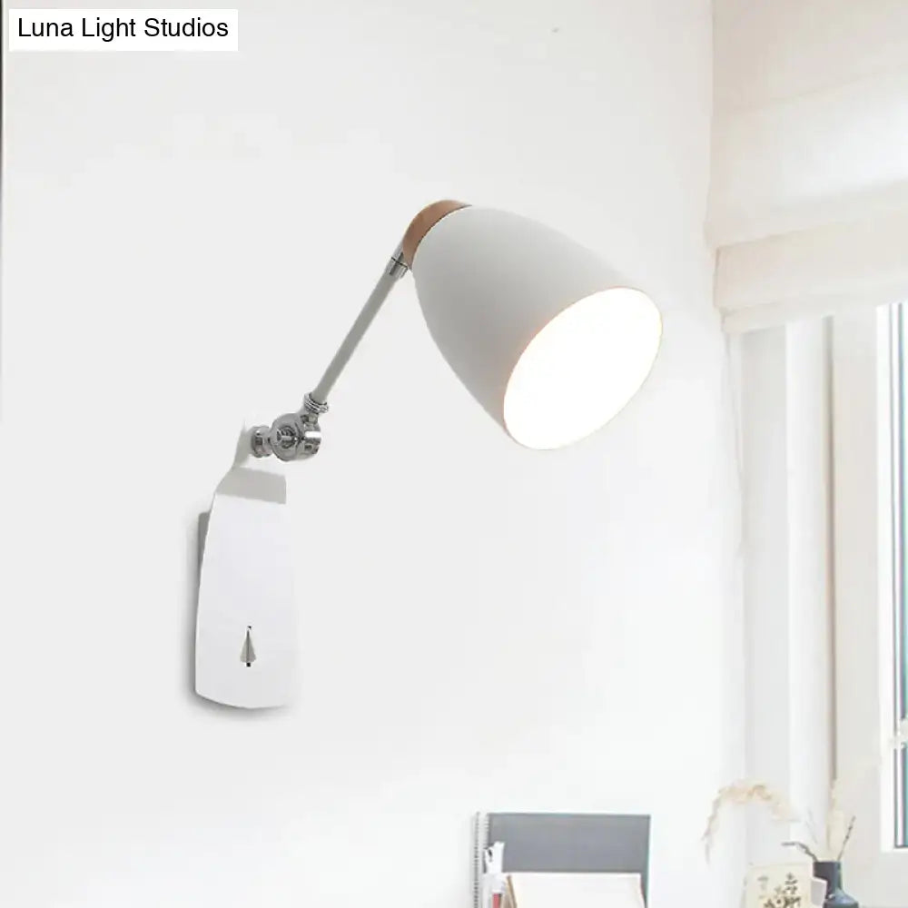 Black and white cup-shaped wall light with adjustable arm and metal wall mount, lit room on Tampa Home & Garden Store