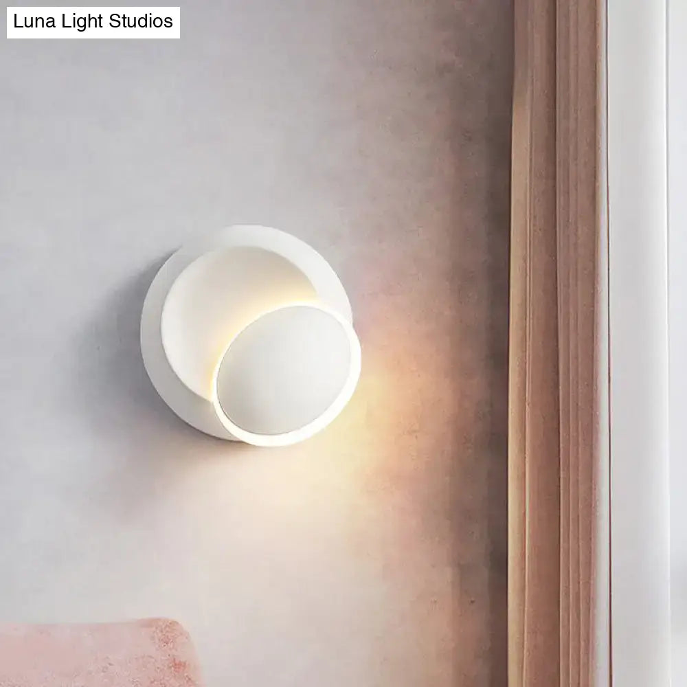 White Eclipse Wall Lamp Decorbites; wall sconce with overlapping discs casting warm light on Tampa Home & Garden Store