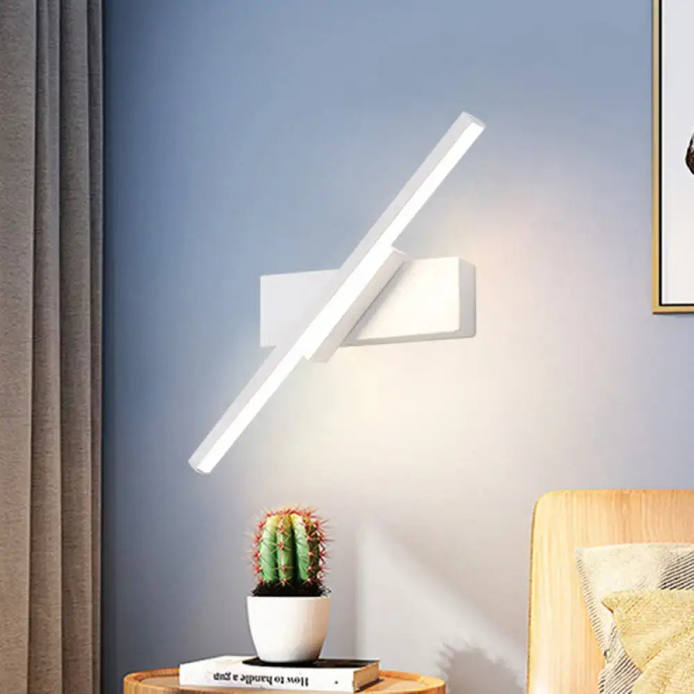 Black Slim LED Sconce wall light by Decorbites with diagonal illuminated bar on blue wall on Tampa Home & Garden Store