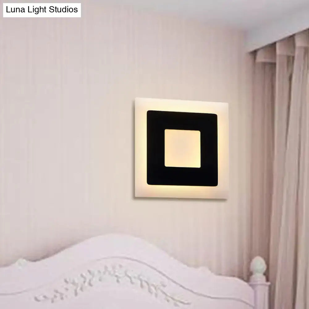 Acrylic square wall sconce with white outer frame and black inner square, warm backlit glow on wall on Tampa Home & Garden Store