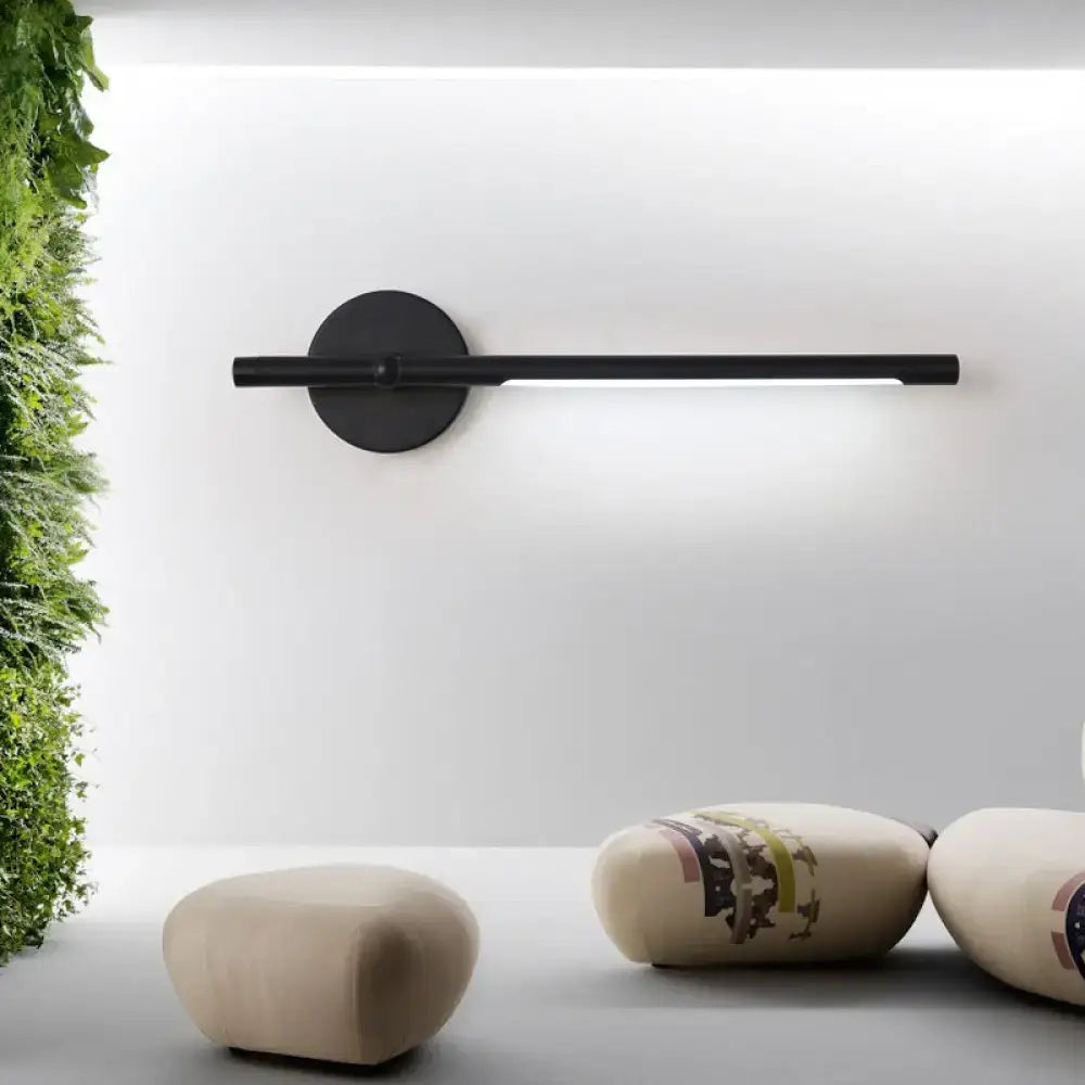 Metal tubular wall sconce direct-wired by Decorbites, black finish with round backplate on Tampa Home & Garden Store