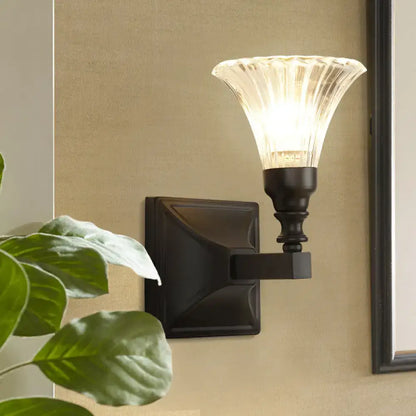 Black flare flush sconce with clear ribbed glass shade and square backplate by Decorbites on Tampa Home & Garden Store