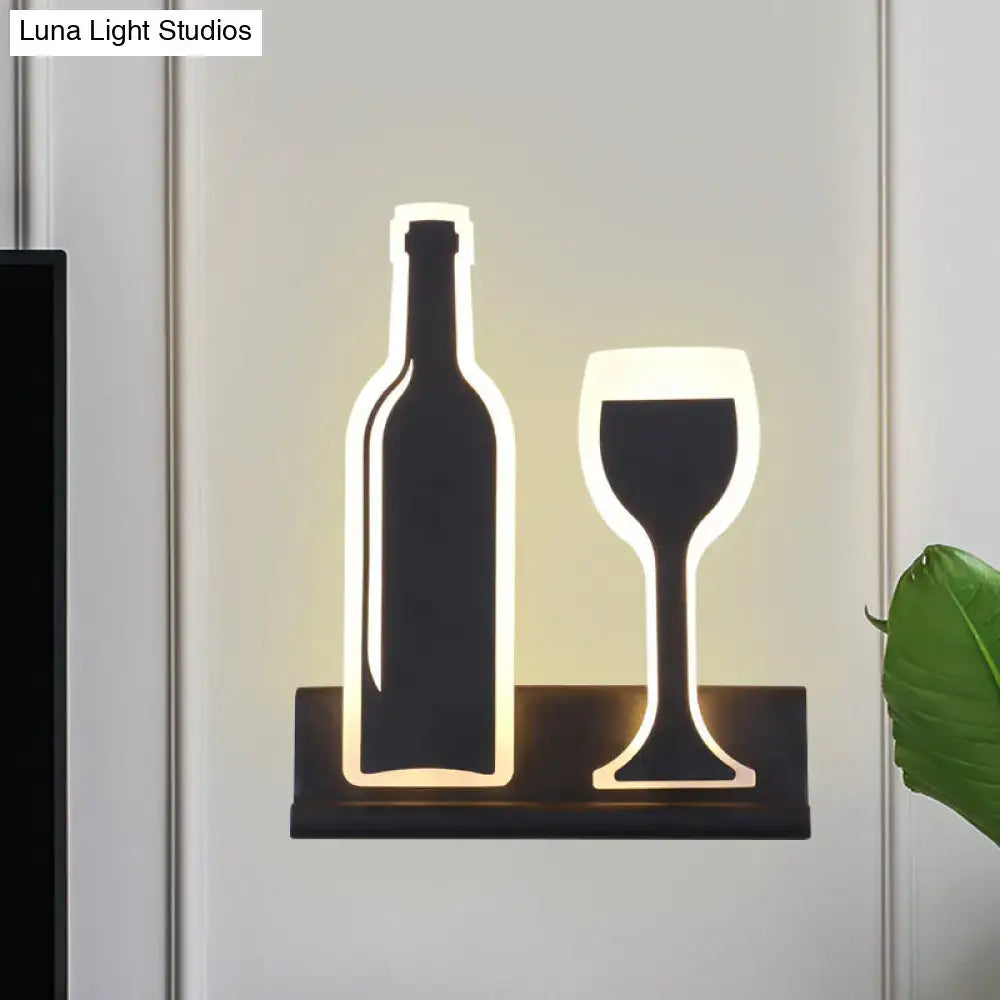 Decorbites black cast iron sconce with illuminated bottle and wine glass silhouettes on Tampa Home & Garden Store