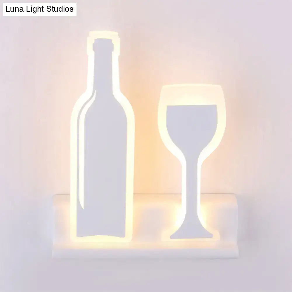 Black cast-iron industrial sconce by Decorbites with wine bottle and glass silhouette, warm glow on Tampa Home & Garden Store