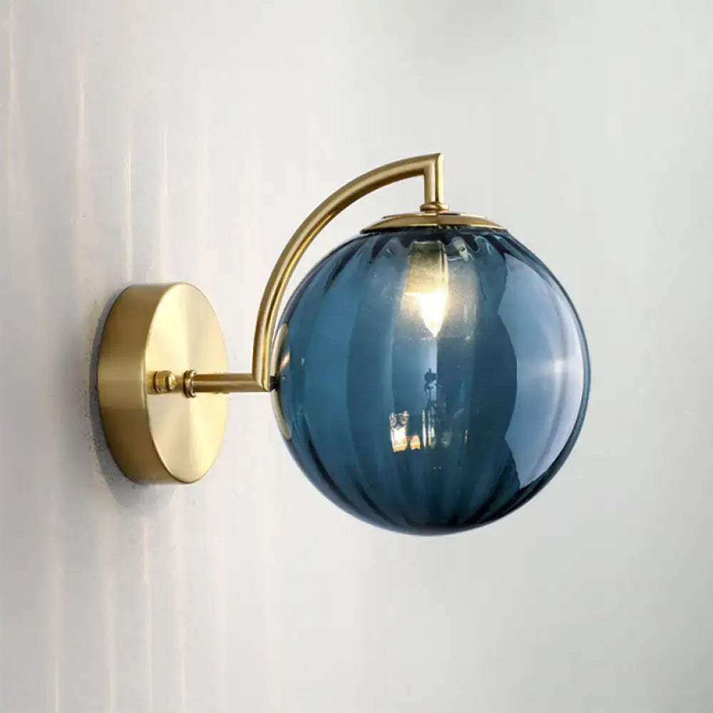 Decorbites gold ribbed blue glass bedroom wall sconce with brass arm on Tampa Home & Garden Store