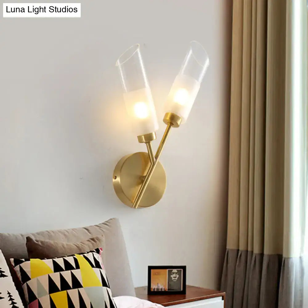 Brass glass two-light wall sconce with cylindrical glass shades, wall mounted on Tampa Home & Garden Store