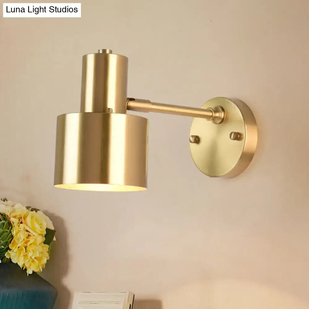 Brass adjustable wall spotlight with cylindrical shade mounted on round wall plate on Tampa Home & Garden Store