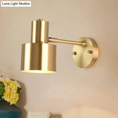Brass adjustable wall spotlight with cylindrical shade mounted on round wall plate on Tampa Home & Garden Store
