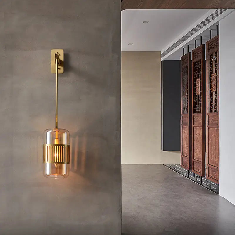 Amber glass cylindrical sconce with brass gold-tone mount and ribbed center band by Decorbites on Tampa Home & Garden Store