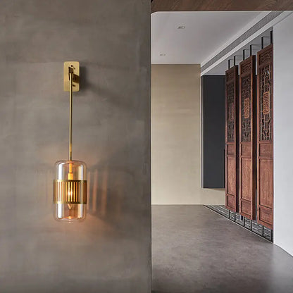 Amber glass cylindrical sconce with brass gold-tone mount and ribbed center band by Decorbites on Tampa Home & Garden Store