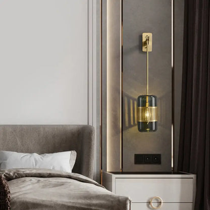 Amber glass cylindrical blackish green sconce by Decorbites with brass accent on wall on Tampa Home & Garden Store