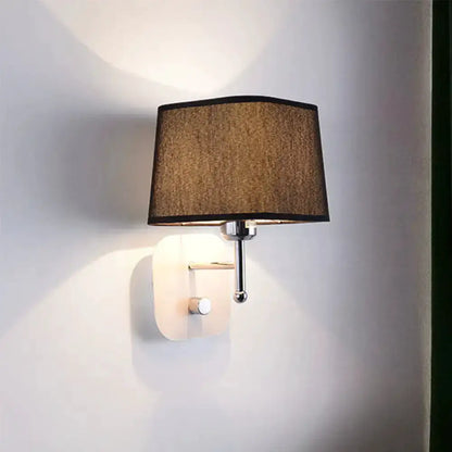 Wall sconce lamp in modern brass with beige linen shade, bedroom lighting on Tampa Home & Garden Store