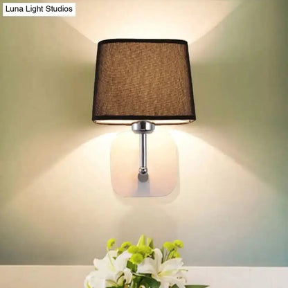 Modern brass and beige linen wall sconce by Decorbites with square backplate bedroom lamp on Tampa Home & Garden Store
