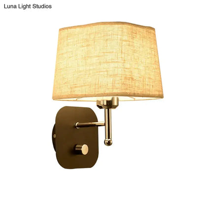 Brass wall sconce with beige linen shade by Decorbites for bedroom lighting on Tampa Home & Garden Store
