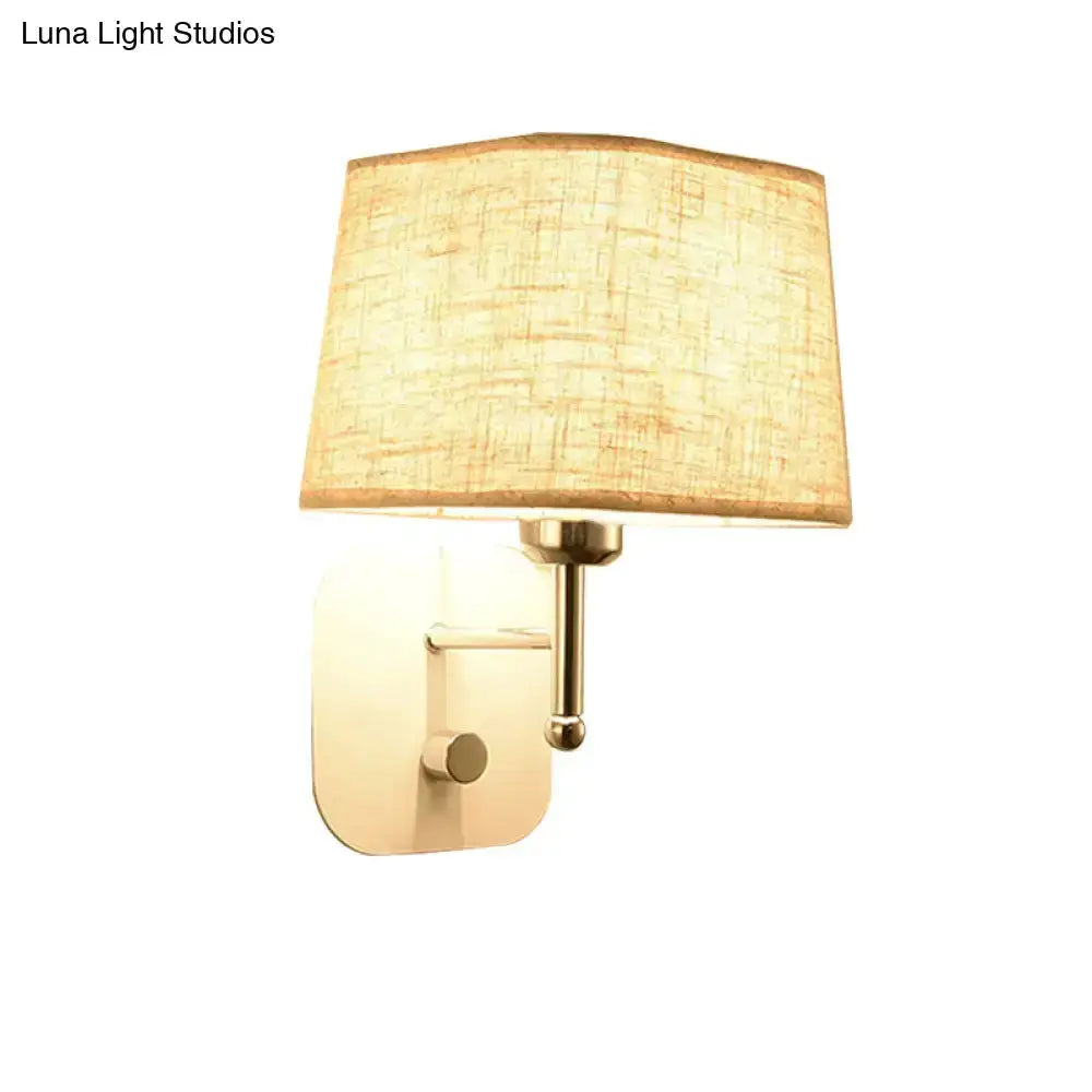 Decorbites modern brass wall sconce with beige linen shade on Tampa Home & Garden Store