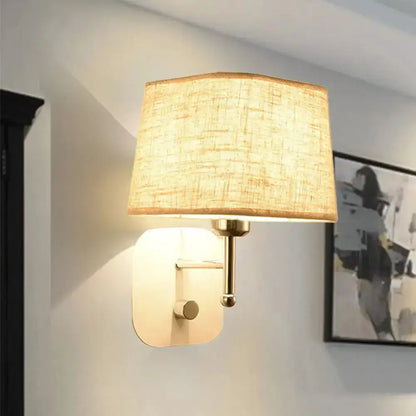 Brass and beige linen wall sconce with shade for bedroom lighting on Tampa Home & Garden Store