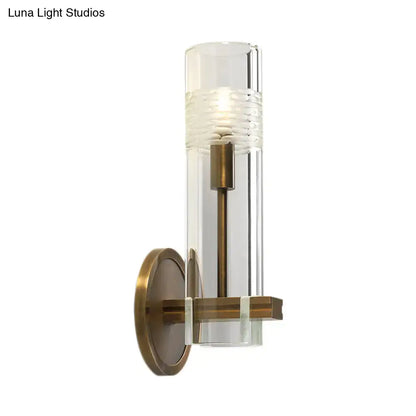 Brass glass tubular wall sconce with clear cylindrical shade by Decorbites on Tampa Home & Garden Store