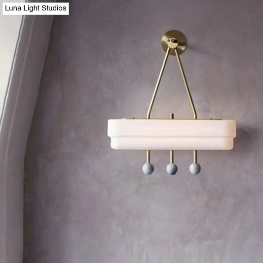 Modern brass and gray sconce with white shade and three hanging spheres Decorbites on Tampa Home & Garden Store